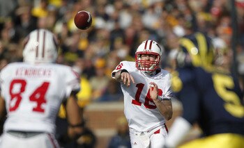 ANN ARBOR, MI - NOVEMBER 20:  Scott Tolzien #16 of the Wisconsin Badgers throws a second quarter pass to Lance Kendricks #84 in front of Courtney Avery #5 of the Michigan Wolverines at Michigan Stadium on November 20, 2010 in Ann Arbor, Michigan.  (Photo