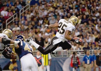 ST. LOUIS - NOVEMBER 15:  Reggie Bush #25 of the New Orleans Saints leaps for the endzone during the game against the St. Louis Rams at the Edward Jones Dome on November 15, 2009 in St. Louis, Missouri.  (Photo by Dilip Vishwanat/Getty Images)