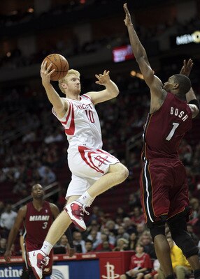 HOUSTON - DECEMBER 29: Chase Budinger #10 of the Houston Rockets drives the basket over Chris Bosh #1 of the Miami Heat in the second half at Toyota Center on December 29, 2010 in Houston, Texas. Miami won 125-119. NOTE TO USER: User expressly acknowledge