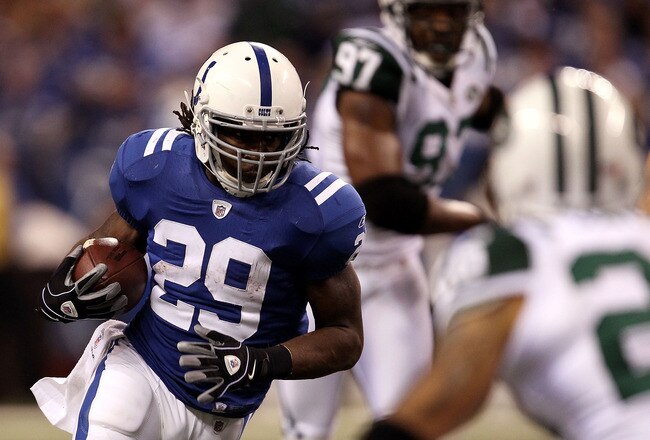 INDIANAPOLIS, IN - JANUARY 08:  Joseph Addai #29 of the Indianapolis Colts runs the ball against the New York Jets during their 2011 AFC wild card playoff game at Lucas Oil Stadium on January 8, 2011 in Indianapolis, Indiana.  The Jets won 17-16. (Photo b