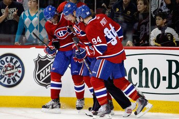 MONTREAL- NOVEMBER 13:  Andrei Markov #79 of the Montreal Canadiens is helped off the ice by teammates P.K. Subban #76 and Tom Pyatt #94 during the NHL game against the Carolina Hurricanes at the Bell Centre on November 13, 2010 in Montreal, Quebec, Canad
