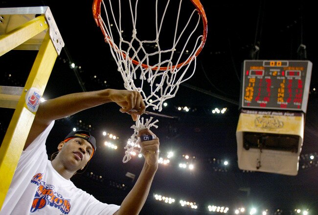 NEW ORLEANS - APRIL 7:  Carmelo Anthony #15 of Syracuse cuts down the net after he and his team defeated Kansas 81-78 during the championship game of the NCAA Men's Final Four Tournament on April 7, 2003 at the Louisiana Superdome in New Orleans, Louisian
