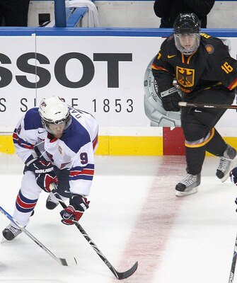 BUFFALO, NY - DECEMBER 30: Jerry D Amigo #9 and Brock Nelson #8 of the United States skate against Marcel Noebels #15 and Tobias Rieder #16 of Germany during the 2011 IIHF World U20 Championship game between United States and Germany at the HSBC Arena on