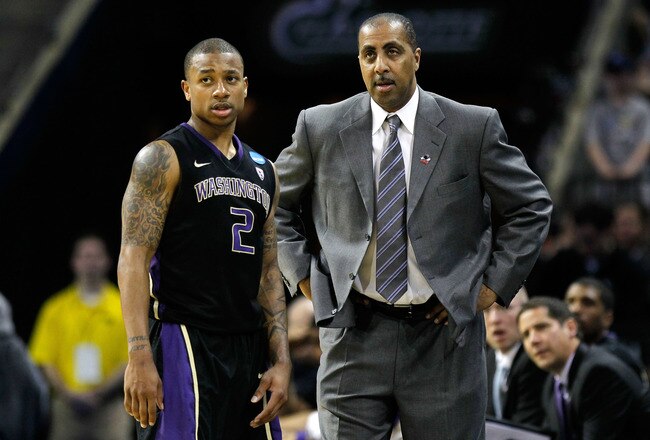 CHARLOTTE, NC - MARCH 20:  Isaiah Thomas #2 talks with head coach Lorenzo Romar of the Washington Huskies while taking on the North Carolina Tar Heels during the third round of the 2011 NCAA men's basketball tournament at Time Warner Cable Arena on March
