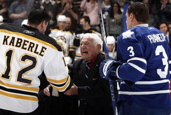 TORONTO, CANADA - MARCH 19: Howie Meeker shakes Tomas Kaberle #12 of the Boston Bruins' hand  with Dion Phaneuf #3 of the Toronto Maple Leafs before game action at the Air Canada Centre March 19, 2011 in Toronto, Ontario, Canada. (Photo by Abelimages/Gett
