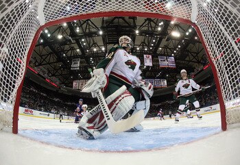 UNIONDALE, NY - MARCH 02:  Niklas Backstrom #32 of the Minnesota Wild defends the net against the New York Islanders at the Nassau Coliseum on March 2, 2011 in Uniondale, New York. The Islanders defeated the Wild 4-1.  (Photo by Bruce Bennett/Getty Images