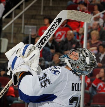 NEWARK, NJ - MARCH 02:  Goalie Dwayne Roloson #35 of the Tampa Bay Lightning looks up during a timeout in an NHL hockey game against the New Jersey Devils at the Prudential Center on March 2, 2011 in Newark, New Jersey.  (Photo by Paul Bereswill/Getty Ima