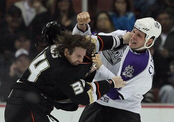 ANAHEIM, CA - NOVEMBER 29:  Kyle Clifford (R) #13 of the Los Angeles Kings throws a punch at Aaron Voros #34 of the Anaheim Ducks during the first period at the Honda Center on November 29, 2010 in Anaheim, California.  (Photo by Jeff Gross/Getty Images)
