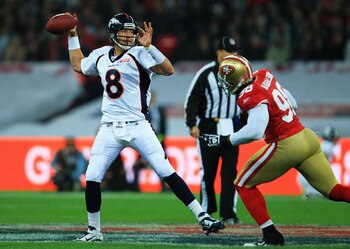 LONDON, ENGLAND - OCTOBER 31:  Kyle Orton #8 of Denver Broncos prepares to release the ball under pressure from Parys Haralston #98 of San Francisco 49ers during the NFL International Series match between Denver Broncos and San Francisco 49ers at Wembley