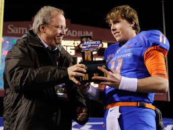 LAS VEGAS, NV - DECEMBER 22:  MAACO President Dave Lapps (L) gives the most valuable player trophy to quarterback Kellen Moore #11 of the Boise State Broncos after the team's 26-3 victory over the Utah Utes in the MAACO Bowl Las Vegas at Sam Boyd Stadium