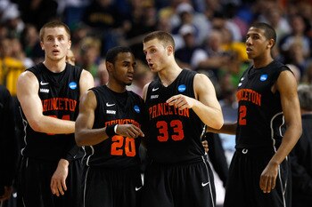 TAMPA, FL - MARCH 17:  (L-R) Ian Hummer #34, Douglas Davis #20, Dan Mavraides #33 and Kareem Maddox #2 of the Princeton Tigers look on against the Kentucky Wildcats during the second round of the 2011 NCAA men's basketball tournament at St. Pete Times For