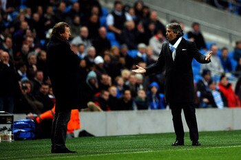 MANCHESTER, ENGLAND - MARCH 17:  Manager Roberto Mancini of Manchester City has words with Manager Yury Semin of Dynamo Kiev during the UEFA Europa League round of 16 second leg match between Manchester City and Dynamo Kiev at City of Manchester Stadium o