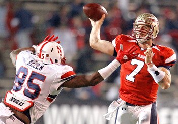 MOBILE, AL - JANUARY 29: Quarterback  Christian Ponder #7 of the South Team passes over defensive lineman Pierre Allen #95 North Team during the fourth quarter of the Under Armour Senior Bowl on January 29, 2011 at Ladd-Pebbles Stadium in Mobile, Alabama.