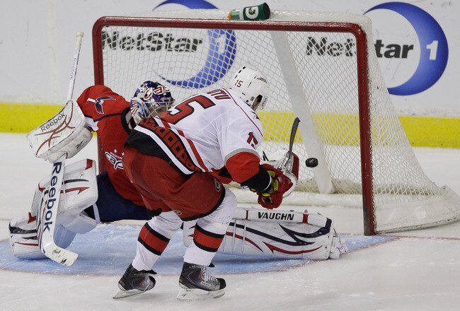 WASHINGTON, DC - MARCH 29:  Tuomo Ruutu #15 of the Carolina Hurricanes scores the game clinching goal on goalie Semyon Varlamov #1 of the Washington Capitals during a shootout at the Verizon Center on March 29, 2011 in Washington, DC. (Photo by Rob Carr/G
