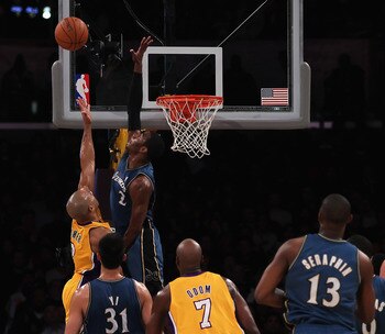 John Wall tries to block Derek Fisher's shot.