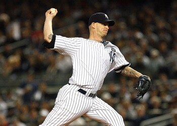 NEW YORK - OCTOBER 19:  A.J. Burnett #34 of the New York Yankees pitches against the Texas Rangers in Game Four of the ALCS during the 2010 MLB Playoffs at Yankee Stadium on October 19, 2010 in the Bronx borough of New York City. The Rangers won 10-3.  (P