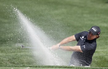 HUMBLE, TX - MARCH 31:  Phil Mickelson hits a shot from a bunker during the first round of the Shell Houston Open at Redstone Golf Club on March 31, 2011 in Humble, Texas.  (Photo by Michael Cohen/Getty Images)