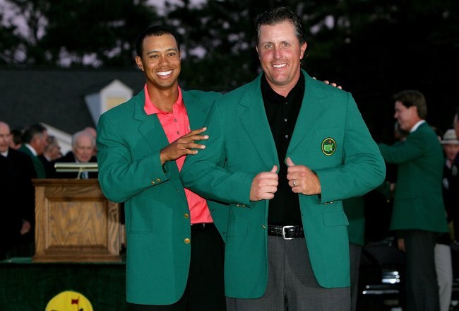 AUGUSTA, GA - APRIL 09:  Tiger Woods and Phil Mickelson pose after Woods put the green jacket on Mickelson after winning The Masters at the Augusta National Golf Club after the final round on April 9, 2006 in Augusta, Georgia.   Mickelson won with the sco