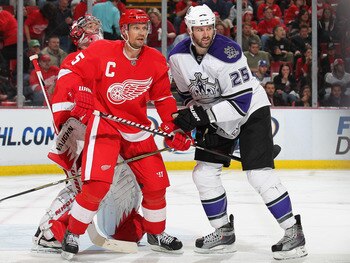 DETROIT, MI - MARCH 9:  Dustin Penner #25 of the Los Angeles Kings is held in check by Nicklas Lidstrom #5 of the Detroit Red Wings in a game on March 9, 2011 at the Joe Louis Arena in Detroit, Michigan. The Kings defeated the Wings 2-1. (Photo by Claus A