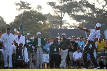 AUGUSTA, GA - APRIL 05:  Tiger Woods reacts to his tee shot on the first hole as Fred Couples and their caddies look on during a practice round prior to the 2010 Masters Tournament at Augusta National Golf Club on April 5, 2010 in Augusta, Georgia.  (Phot