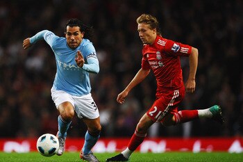 MANCHESTER, ENGLAND - AUGUST 23: Carlos Tevez of Manchester City battles for the ball with Lucas of Liverpool during the Barclays Premier League match between Manchester City and Liverpool at City of Manchester Stadium on August 23, 2010 in Manchester, En