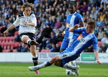 Luka Modric is denied by Wigan's James McCarthy as Spurs struggle in their 0-0 draw with the Latics