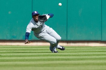 ST. LOUIS, MO - MARCH 31: Cameron Maybin #24 of the San Diego Padres makes a sliding catch against the St. Louis Cardinals on opening day at Busch Stadium on March 31, 2011 in St. Louis, Missouri.  (Photo by Dilip Vishwanat/Getty Images)