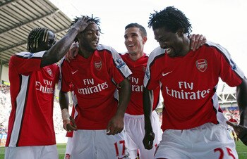 WIGAN, ENGLAND - APRIL 11:  Alexandre Song of Arsenal celebrates scoring the fourth goal with Emmanuel Adebayor during the Barclays Premier League match between Wigan Athletic and Arsenal at The JJB Stadium on April 11, 2009 in Wigan, England.  (Photo by