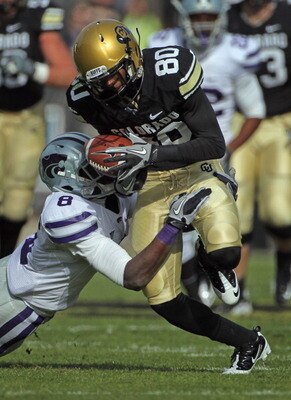 BOULDER, CO - NOVEMBER 20:  Wide receiver Paul Richardson #80 of the Colorado Buffaloes makes a pass reception for a first down as defensive back Stephen Harrison #8 of the Kansas State Wildcats makes the tackle at Folsom Field on November 20, 2010 in Bou