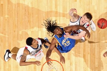 DENVER, CO - MARCH 19:  Kenneth Faried #35 of the Morehead State Eagles fights for a loose ball against Justin Harper #32 and Dan Geriot #41 of the Richmond Spiders during the third round of the 2011 NCAA men's basketball tournament at Pepsi Center on Mar