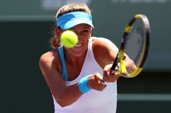 KEY BISCAYNE, FL - APRIL 02:  Victoria Azarenka of Belarus hits a backhand return against Maria Sharapova of Russia during the women's singles championship at the Sony Ericsson Open at Crandon Park Tennis Center on April 2, 2011 in Key Biscayne, Florida.