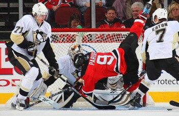 NEWARK, NJ - DECEMBER 10: Goaltender Dany Sabourin #30 of the Pittsburgh Penguins blocks a shot by Zach Parise #9 of the New Jersey Devils as Evgeni Malkin #71 looks for the rebound on December 10, 2008 at the Prudential Center in Newark, New Jersey. (Pho