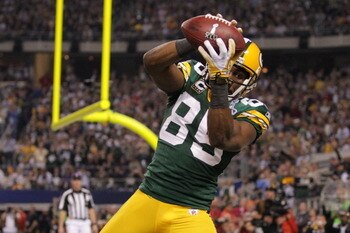 ARLINGTON, TX - FEBRUARY 06:  Greg Jennings #85 of the Green Bay Packers catches a a fourth quarter touchdown pass against the Pittsburgh Steelers  during Super Bowl XLV at Cowboys Stadium on February 6, 2011 in Arlington, Texas.  (Photo by Doug Pensinger