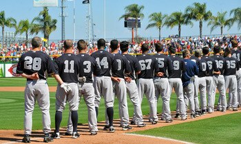 CLEARWATER, FL - FEBRUARY 27:  Manager Joe Girardi #28 and players of the New York Yankees line up for pre-game introduction before play  against the Philadelphia Phillies February 27, 2011 at Bright House Field in Clearwater, Florida.  (Photo by Al Messe