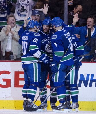 VANCOUVER, CANADA - APRIL 7: Ryan Kesler #17 of the Vancouver Canucks is congratulated by teammates Chris Higgins #20, Sami Salo #6 and Mikael Samuelsson #26 after scoring his third goal of the game against the Minnesota Wild during the third period in NH
