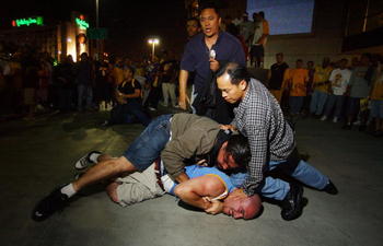 LOS ANGELES - JUNE 12:  Plain clothes police officers press a man to the ground after a scuffle broke out after the Lakers swept their third consecutive NBA National Championship title June 12, 2002 in Los Angeles, California. Some 18,000 fans gathered in