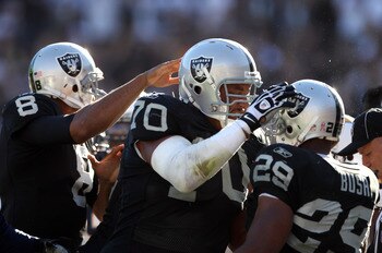 OAKLAND, CA - OCTOBER 10:  Michael Bush #29 is congratulated by Langston Walker #70 and Jason Campbell #8 of the Oakland Raiders after Bush scored a touchdwon against the San Diego Chargers at Oakland-Alameda County Coliseum on October 10, 2010 in Oakland