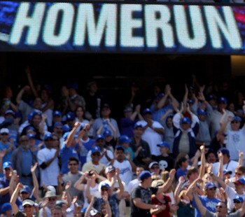 LOS ANGELES, CA - APRIL 18:  Fans celebrate as Manny Ramirez #99 of the Los Angeles Dodgers rounds third base after hitting a two-run homerun in the eighth inning against the San Francisco Giants at Dodger Stadium on April 18, 2010 in Los Angeles, Califor