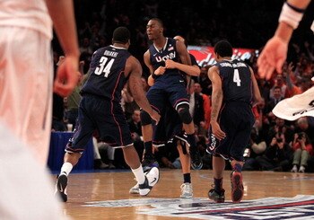 NEW YORK, NY - MARCH 10: Alex Oriakhi #34, Kemba Walker #15 and Jamal Coombs-McDaniel #4 of the Connecticut Huskies celebrate after walker hit the game winning basket against the Pittsburgh Panthers during the quarterfinals of the 2011 Big East Men's Bask