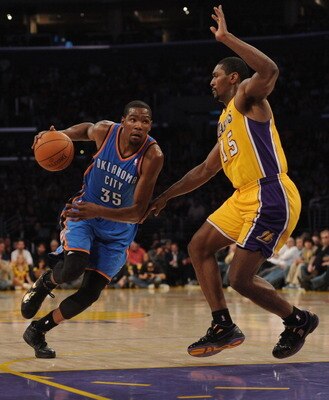 LOS ANGELES, CA - JANUARY 17:  Kevin Durant #35 of the Oklahoma City Thunder dribbles to the basket around Ron Artest #15 of the Los Angeles Lakers at the Staples Center on January 17, 2011 in Los Angeles, California.   NOTE TO USER: User expressly acknow