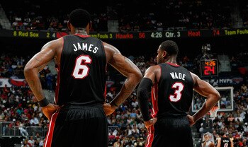 ATLANTA, GA - APRIL 11:  LeBron James #6 and Dwyane Wade #3 of the Miami Heat stand during a free throw against the Atlanta Hawks at Philips Arena on April 11, 2011 in Atlanta, Georgia.  NOTE TO USER: User expressly acknowledges and agrees that, by downlo