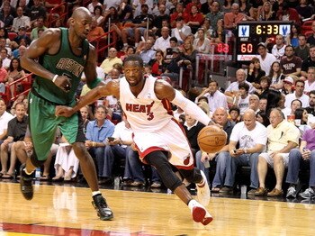 MIAMI, FL - APRIL 10:  Dwyane Wade #3 of the Miami Heat drives on Kevin Garnett #5 of the Boston Celtics during a game  at American Airlines Arena on April 10, 2011 in Miami, Florida. NOTE TO USER: User expressly acknowledges and agrees that, by downloadi