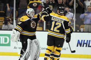 BOSTON, MA - MARCH 24:  Tim Thomas #30 of the Boston Bruins is congratulated by teammates Tomas Kaberle #12 and Patrice Bergeron #37 after Thomas shut out the Montreal Canadiens on March 24, 2011 at the TD Garden in Boston, Massachusetts.  The Boston Brui