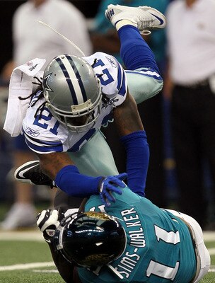 ARLINGTON, TX - OCTOBER 31:  Wide receiver Mike Sims-Walker #11 of the Jacksonville Jaguars is tackled by Mike Jenkins #21 of the Dallas Cowboys at Cowboys Stadium on October 31, 2010 in Arlington, Texas.  (Photo by Stephen Dunn/Getty Images)