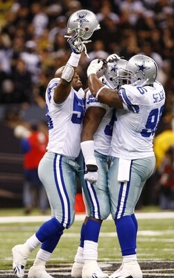NEW ORLEANS - DECEMBER 19:  Bradie James #56, DeMarcus Ware #94 and Marcus Spears #96 of the Dallas Cowboys celebrate after Ware sacked quarterback Drew Brees #9 of the New Orleans Saints to end the game at the Louisiana Superdome on December 19, 2009 in