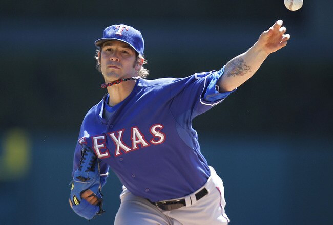 DETROIT, MI - APRIL 12:  C.J. Wilson #36 of thde Texas Rangers thows a warm up pitch while playing the Detroit Tigers at Comerica Park on April 12, 2011 in Detroit, Michigan.  (Photo by Gregory Shamus/Getty Images)