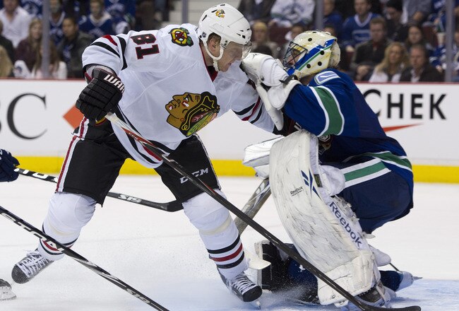 VANCOUVER, CANADA - APRIL 13: Marian Hossa #81 of the Chicago Blackhawks skates into goalie Roberto Luongo #1 after getting pushed during the third period in Game One of the Western Conference Quarterfinals during the 2011 NHL Stanley Cup Playoffs on Apri