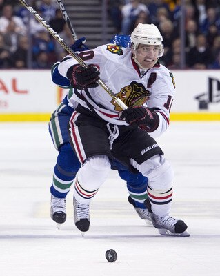 VANCOUVER, CANADA - FEBRUARY 4: Patrick Sharp #10 of the Chicago Blackhawks chases the loose puck with Cody Hodgson #39 of the Vancouver Canucks in pursuit during the third period in NHL action on February 04, 2011 at Rogers Arena in Vancouver, British Co