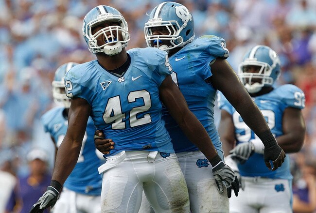 CHAPEL HILL, NC - SEPTEMBER 19:  Robert Quinn #42 of the North Carolina Tar Heels celebrates after a sack with teammate Marvin Austin #9 against the East Carolina Pirates at Kenan Stadium on September 19, 2009 in Chapel Hill, North Carolina.  (Photo by St