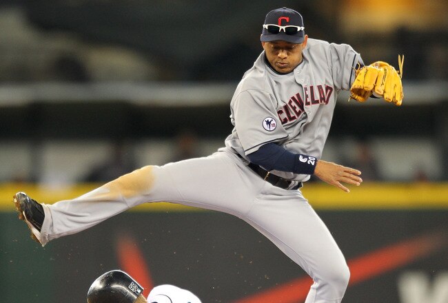 SEATTLE - APRIL 10:  Second baseman Orlando Cabrera #20 of the Cleveland Indians hops over Michael Saunders #55 of the Seattle Mariners on a double play in the fifth inning at Safeco Field on April 10, 2011 in Seattle, Washington. (Photo by Otto Greule Jr